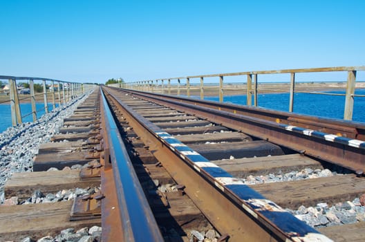 rail road bridge under cloudy blue sky