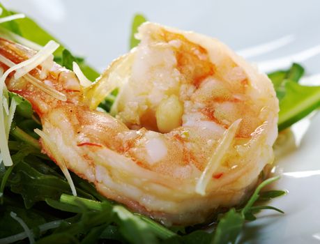 arugula salad with prawn on plate closeup