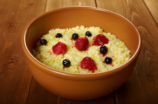 Millet porridge with berry in brown bowl on table