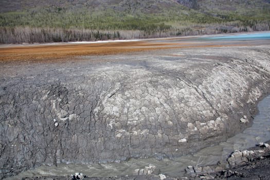 A wall of mud and clay near the end of a remote alpine lake