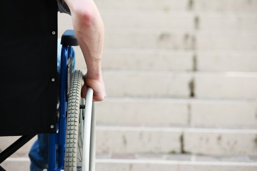 Wheelchair user in front of staircase Barrier 
