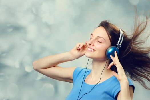 Beautiful girl listening to music on headphones