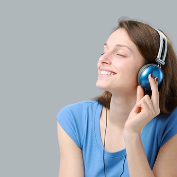 Beautiful girl listening to music on headphones