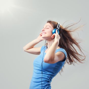 Beautiful girl listening to music on headphones