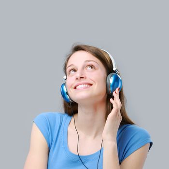 Beautiful girl listening to music on headphones