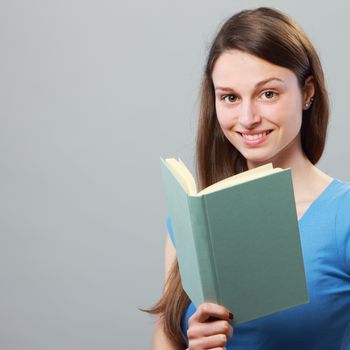 Female young student reading a book