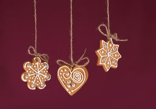 Christmas gingerbreads hanging in traditional linen string