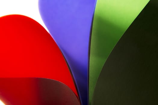 closeup of curved colorful papers in red, blue and green