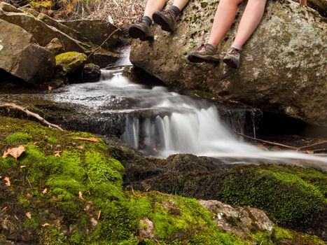 Couple resting by a stream