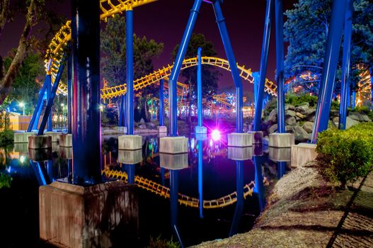 A rollercoaster at a theme park in USA at night