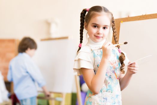 portrait of a girl standing next to his easel, a drawing lesson