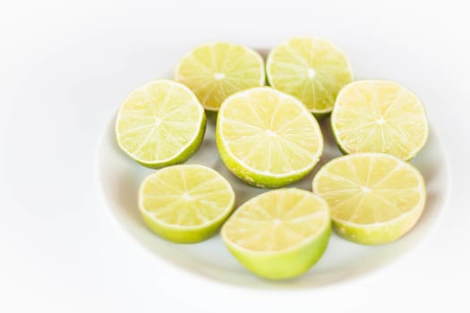 Fresh lime slice on white ceramic dish
