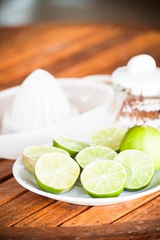 Fresh citrus lime wholes and slice with hand squash tool