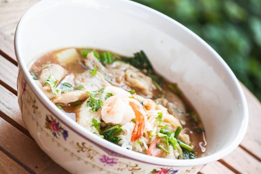 Thai noodles  with pork and seafood in spicy soup