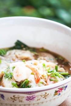 Close up shrimp topped on spicy noodles soup