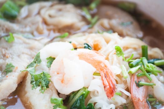 Close up shrimp topped on thai style spicy noodles soup