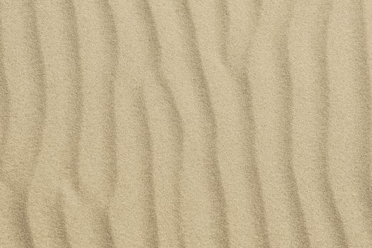 Picture of golden sand with small waves