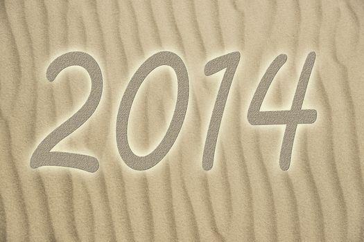 Picture of golden sand with small waves and letters 2014