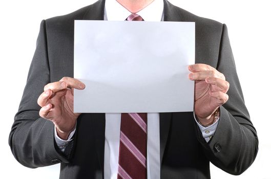 Businessman holding a blank sheet of paper with room for text