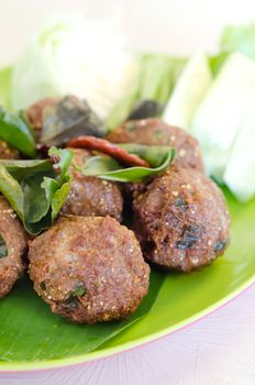 Meatballs with greens on salad leaves