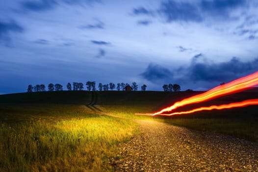 sunset landscape in blue and orange with light trails