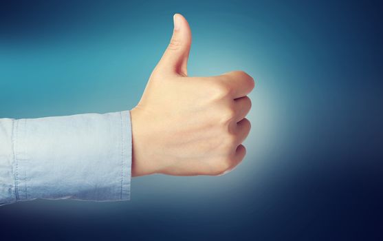 Person giving the thumbs up over blue background