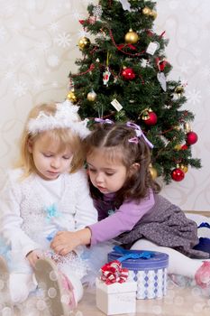 Two girls under Christmas tree