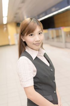 Portrait of young business woman stand in the MRT station, Taipei, Taiwan, Asia.
