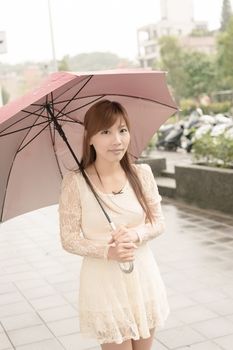 Asian beauty in raining day hold an umbrella in outside, Taipei, Taiwan.