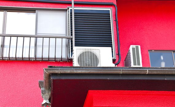 Red walls of the house, looking from the side.