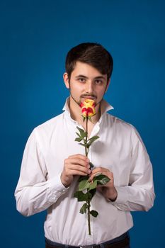 Man giving the red roses, on blue background