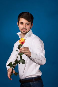 Man giving the red roses, on blue background