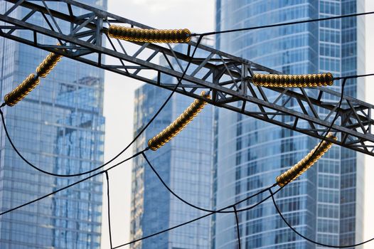 Power lines on the background of modern office buildings.