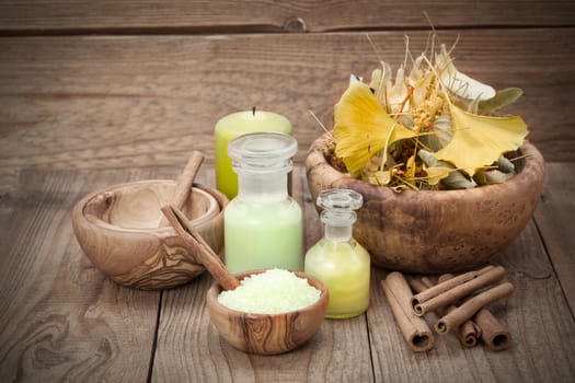 herbal salt in the wooden bowl and herb on wooden background.