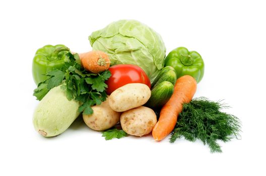 Heap of Raw Vegetables with Cabbage, Carrot, Green Bell Peppers, Squash, Potatoes, Tomato, Cucumbers, Parsley and Dill isolated on white background