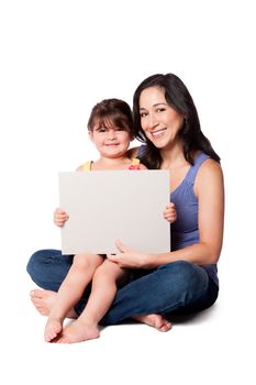 Happy smiling mother, nanny or teacher, and daughter holding whiteboard, childcare concept.