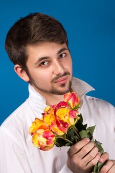 young man giving a red rose, on blue background