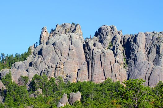 Rock formations scatter the pine forests of Black Hills National Forest in South Dakota.