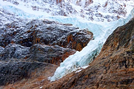 Angel Glacier hangs over a cliff below Mount Edith Cavell in Jasper National Park Canada.