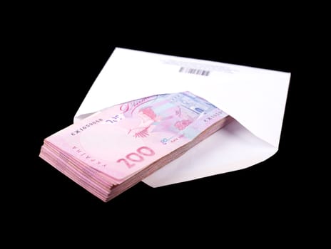 Ukrainian money in a white envelope on a black background