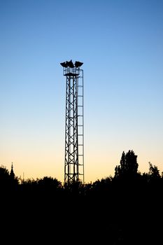 Guard tower silhouette against twilight sky