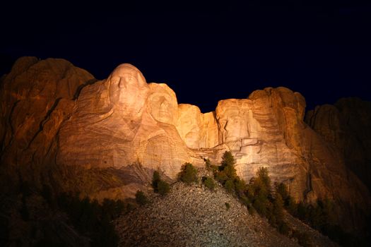 Mount Rushmore National Memorial illuminated at night in South Dakota.