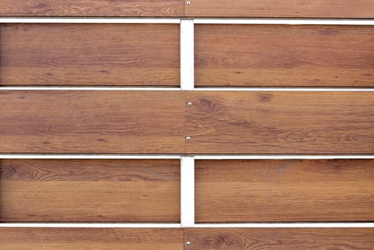 closeup of a textured wooden fence with metal pillar painted white