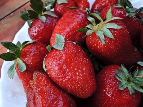 Fresh strawberries on wooden table macro