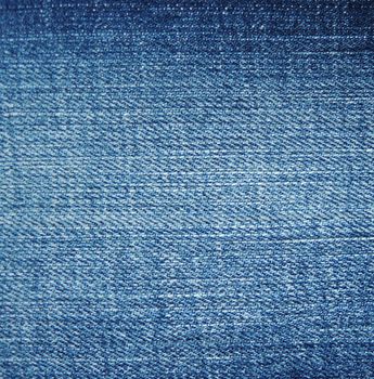 Texture of blue jeans textile close up

