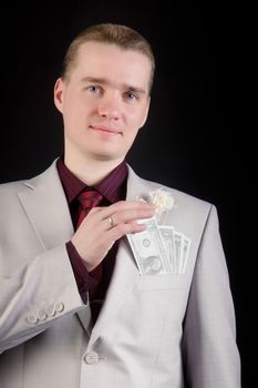 young attractive man in a light suit with banknotes in his pocket