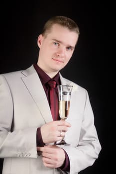 young attractive man in a suit with a glass of champagne