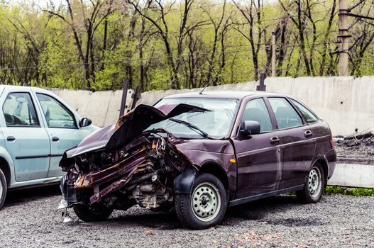 A car in a car wreckers yard after a recent crash