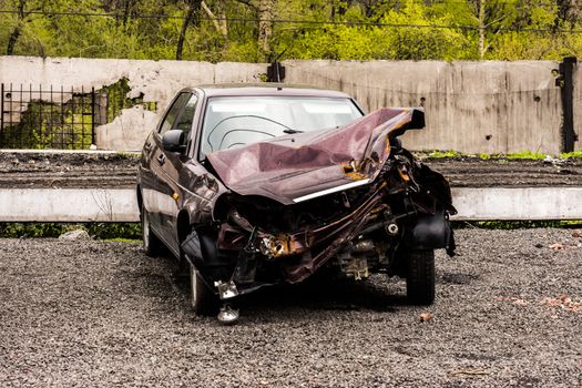 A car in a car wreckers yard after a recent crash