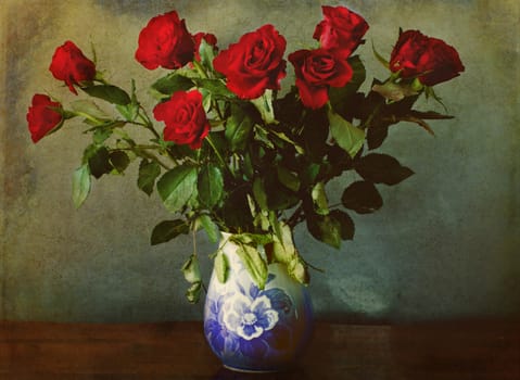 still life: red roses in vase on a grunge background